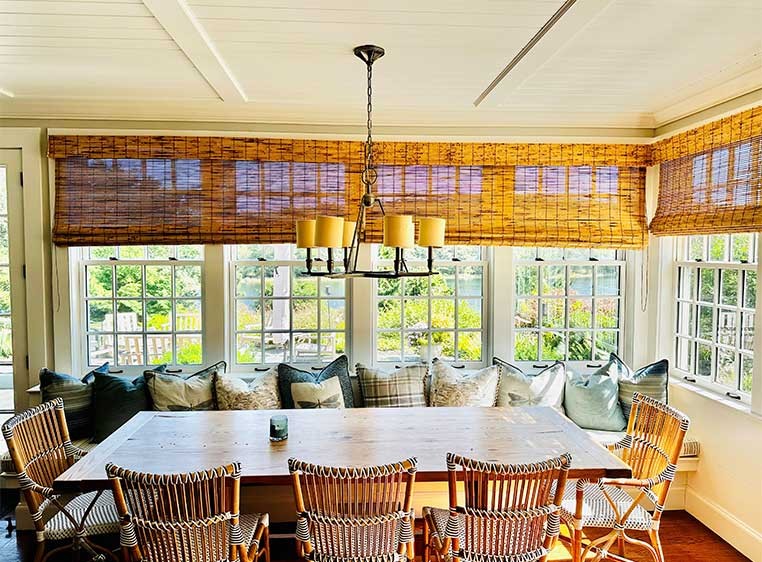 Rustic dining room with wooden chairs and drapes